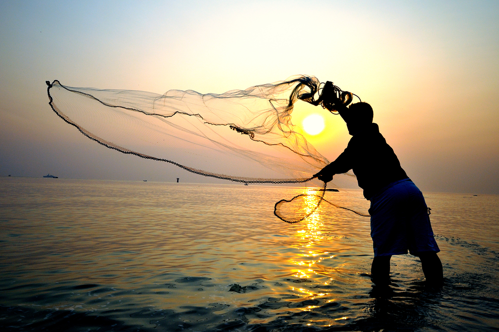 Fisherman throwing fishing net