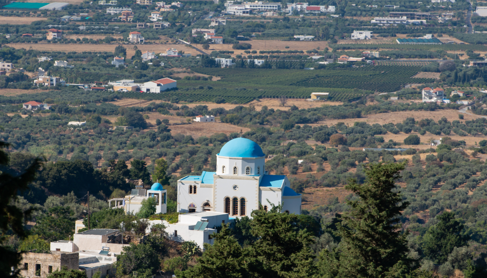 Zia and a blue white village church in front of the Turkish mainland in the north on the island Kos Greece
