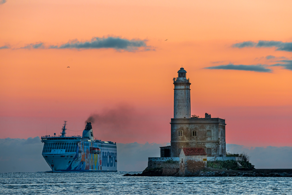 Olbia, province of Sassari, 30 September 2020, 7:20 am. Entrance of the Moby Lines ship in the port of Olbia, on the right the lighthouse on the island of Mouth, Sardinia - Italy