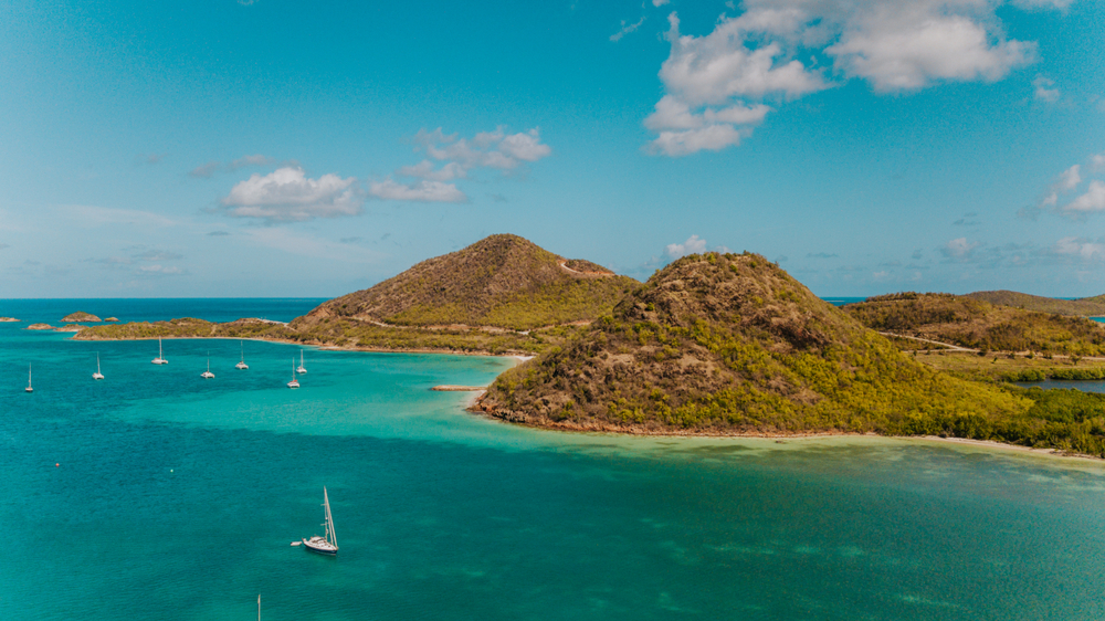 Tropical green mountains surrounded by turquoise waters, exotic bay for sailboats in Antigua, Jolly Harbour for sailors, sailingTropical green mountains surrounded by turquoise waters, exotic bay for sailboats in Antigua, Jolly Harbour for sailors, sailing